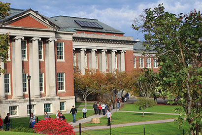 Students walking out of Old Main in the fall